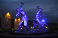 Shipbuilders statue lit purple